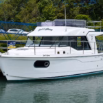 A motorboat tied to a pier inside a quiet marina harbour