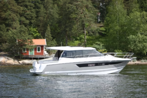 motor cruiser underway, showing the starboard profile, spacious wheelhouse and contemporary hull design